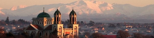Timaru Basilica against snow-capped mountains in the distance